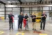 five key members cutting the ribbon at the grand opening of the facility