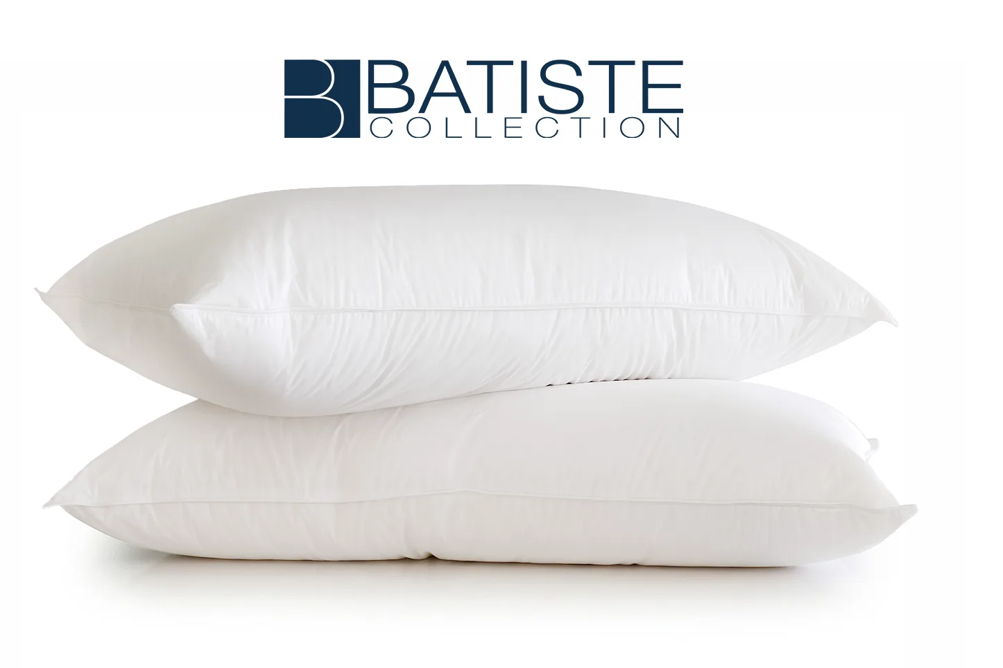 Two white pillows stacked on a white surface with the Batiste Collection logo above them.